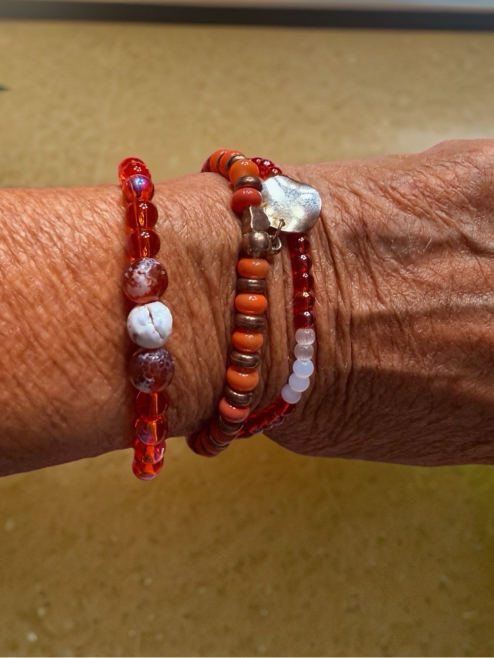Hand Crafted Red and Orange Beaded Bracelet Stack with Silver Heart Charm